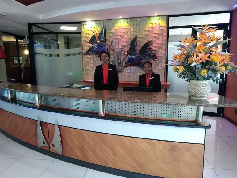 A hotel reception desk with a guest checking in